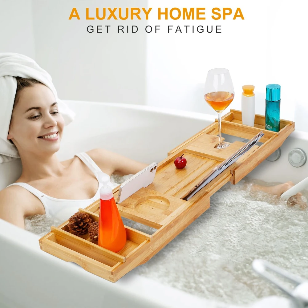Bamboo bathtub tray with wine glass, skincare bottles, phone holder, and decorative elements, enhancing a relaxing home spa experience.