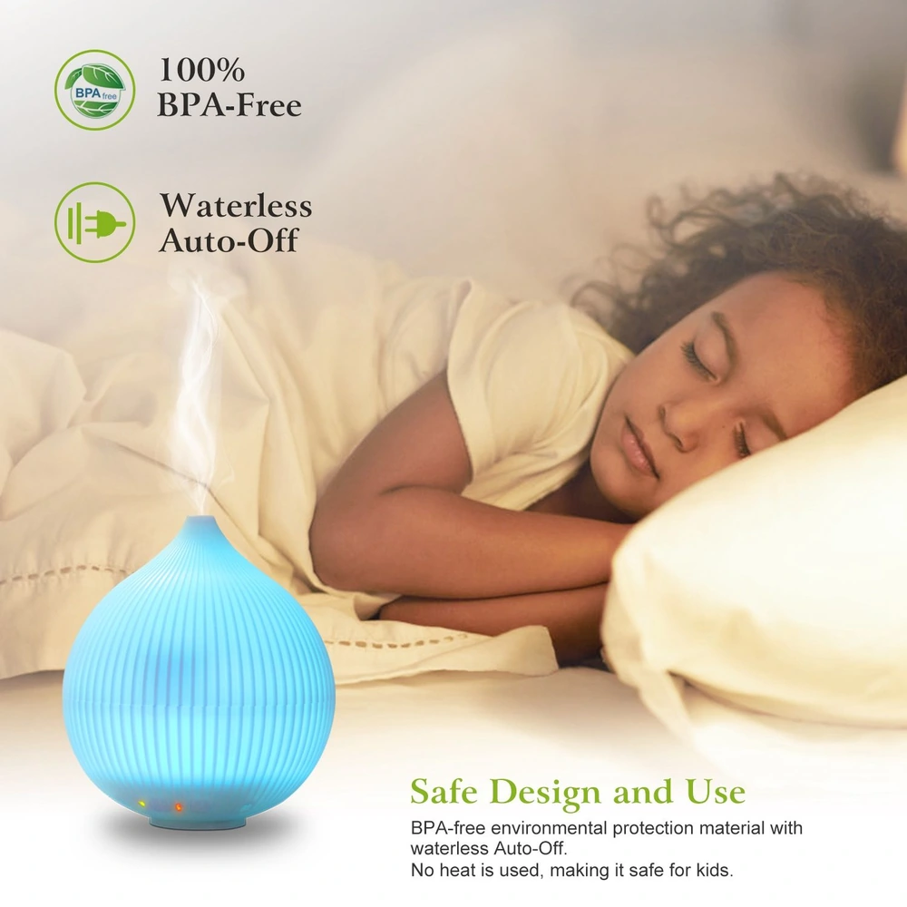 A blue, BPA-free essential oil diffuser with waterless auto-off feature, creating a calming mist while a child peacefully sleeps nearby on a bed.