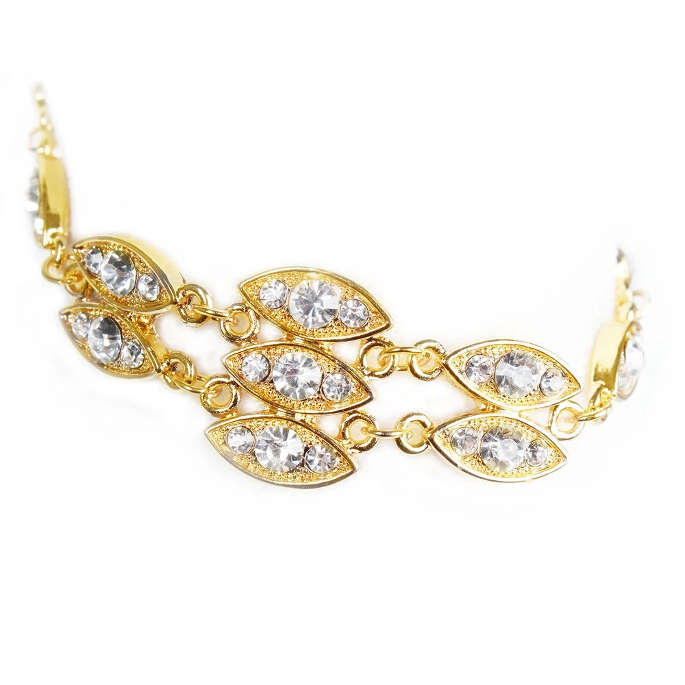 Elegant gold bracelet with eye-shaped links adorned with sparkling clear rhinestones, perfect for adding a touch of glamour to any outfit.