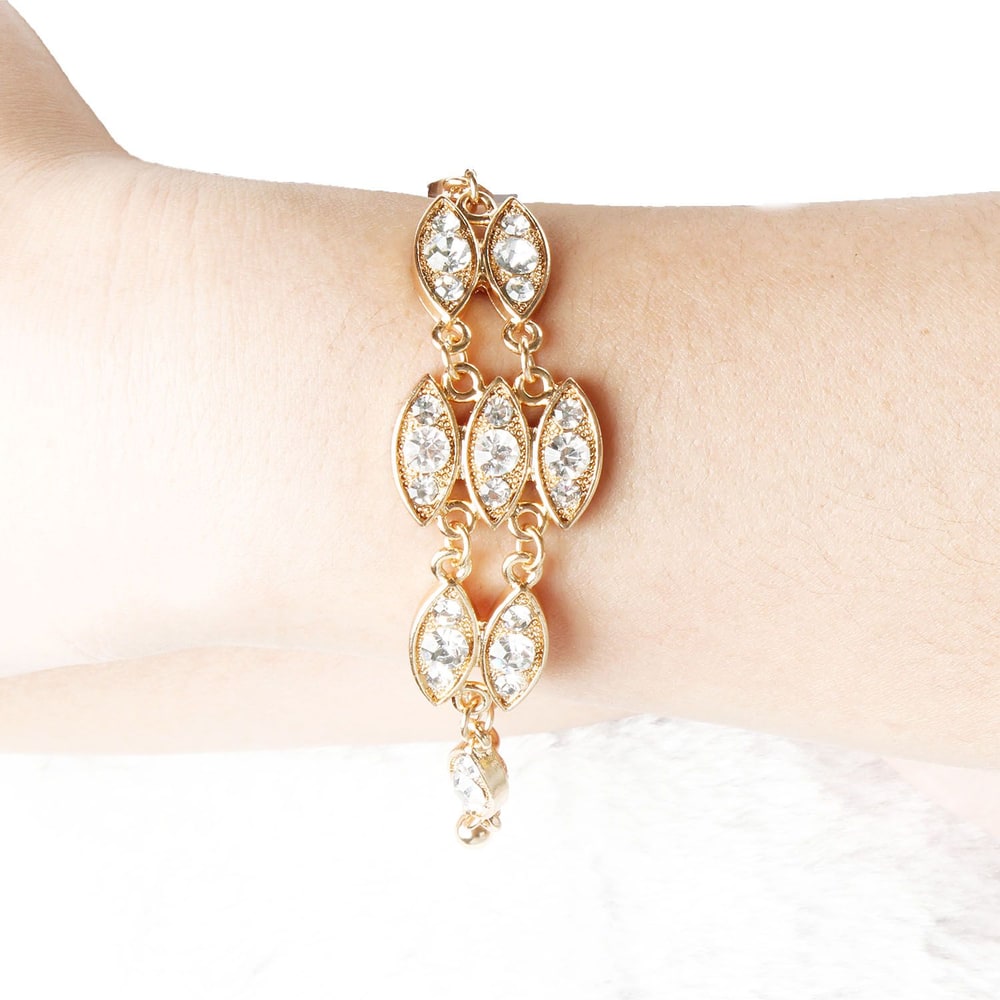 Elegant gold bracelet with marquise-cut crystals showcased on a woman's wrist, perfect for adding a touch of sophistication to any outfit.