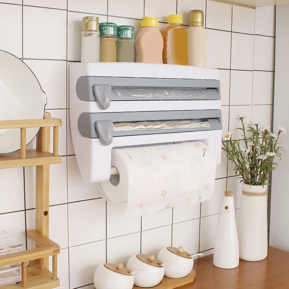 Wall-mounted kitchen organizer with foil and wrap dispensers, paper towel holder, and condiment containers, featuring a stylish design against tiled background.