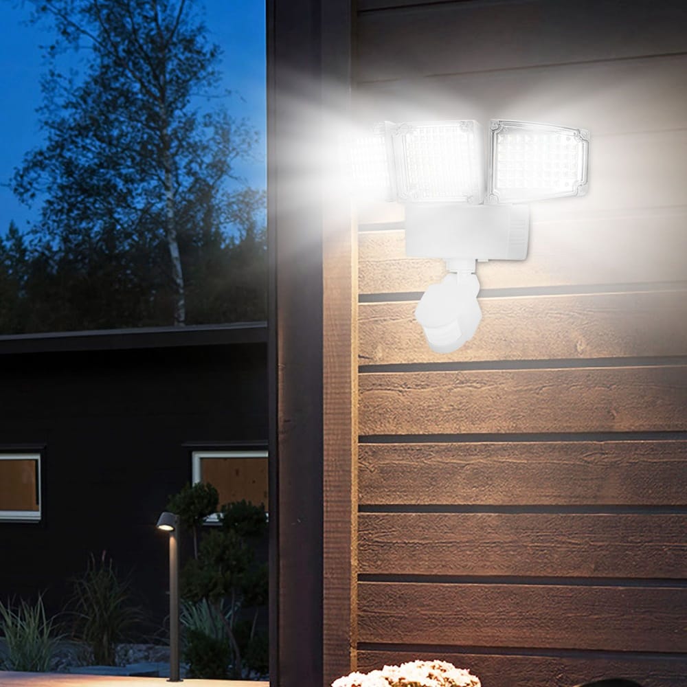 Three-head LED outdoor security light mounted on wooden wall, illuminating surrounding area at dusk, ideal for enhanced nighttime visibility and safety.