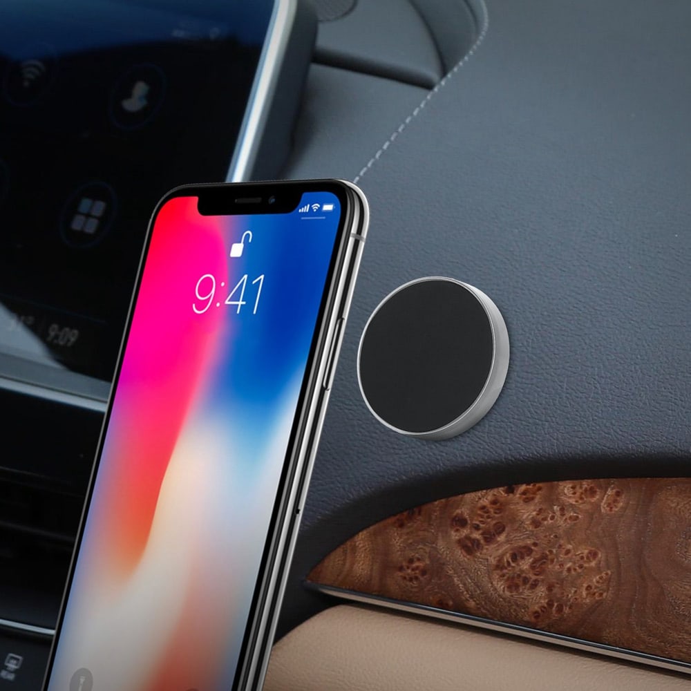 Sleek magnetic phone mount attached to a car dashboard, with an iPhone displaying a lock screen at 9:41, showcasing easy and convenient access to navigation and hands-free calls.