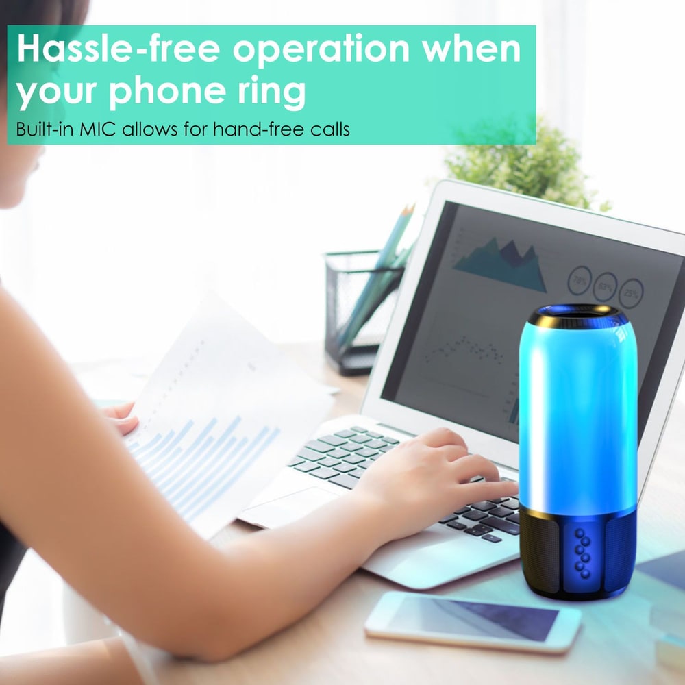 Bluetooth speaker with built-in microphone for hands-free calls, placed on a desk next to a laptop and documents, highlighting user-friendly design and functionality.