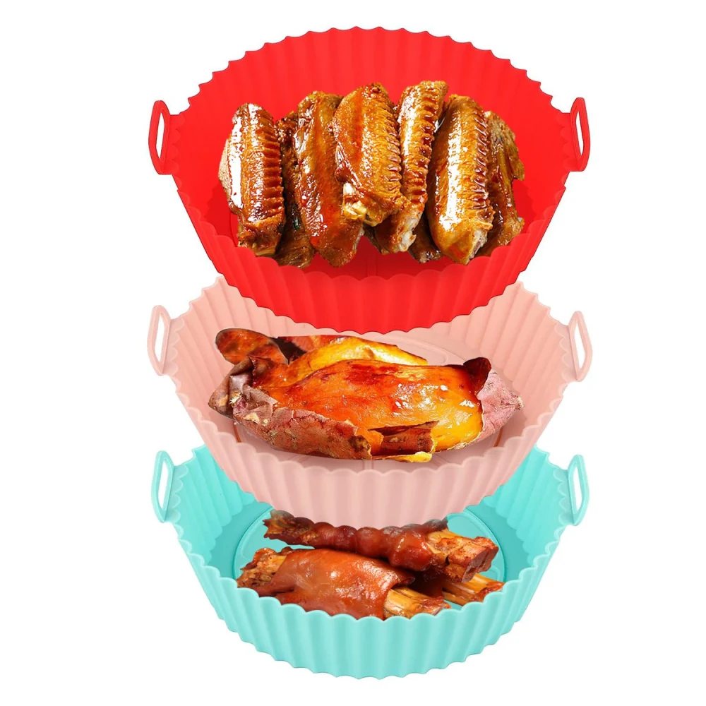 Stackable silicone cooking trays in red, pink, and blue, holding various grilled meats including wings and chicken, perfect for easy serving and clean-up.