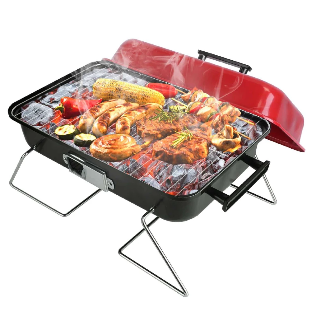 Compact portable grill with sizzling meats and vegetables, including sausages, chicken, corn, and peppers, producing flavorful smoke.