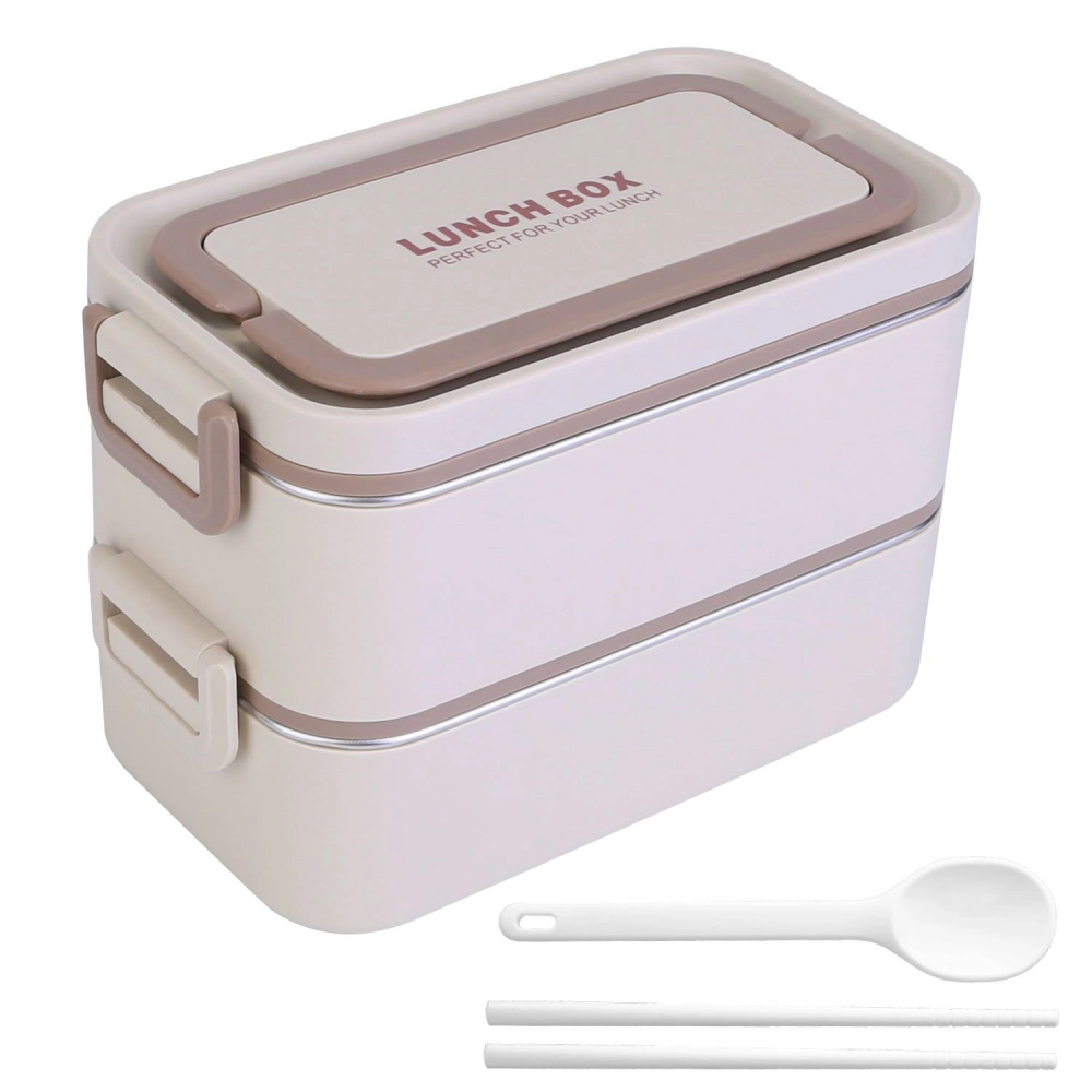 Compact two-tier lunch box with a beige and white design, featuring a secure lid with "LUNCH BOX" text and accompanied by a white spoon and chopsticks. Ideal for meal prep and on-the-go lunches.