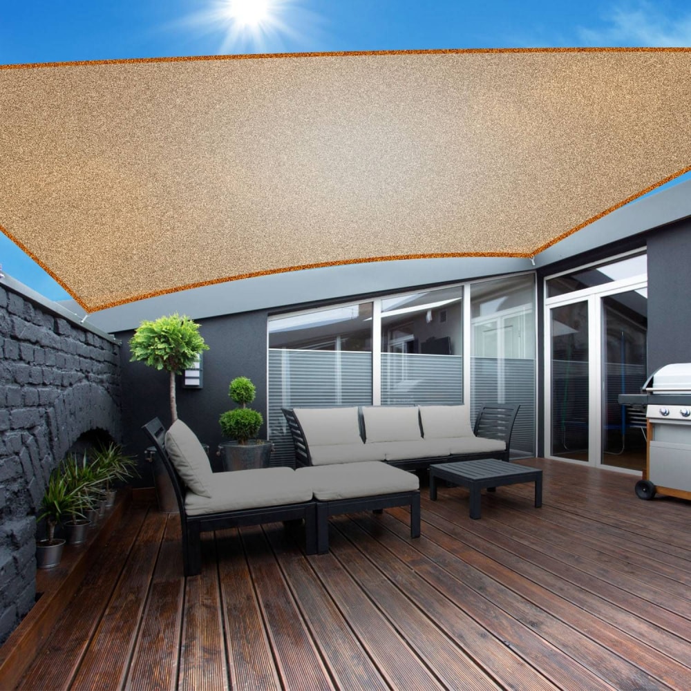 Elegant outdoor patio featuring a stylish beige sunshade overhead, modern black seating with plush cushions, and a charcoal grill, set on a wooden deck illuminated by sunlight.