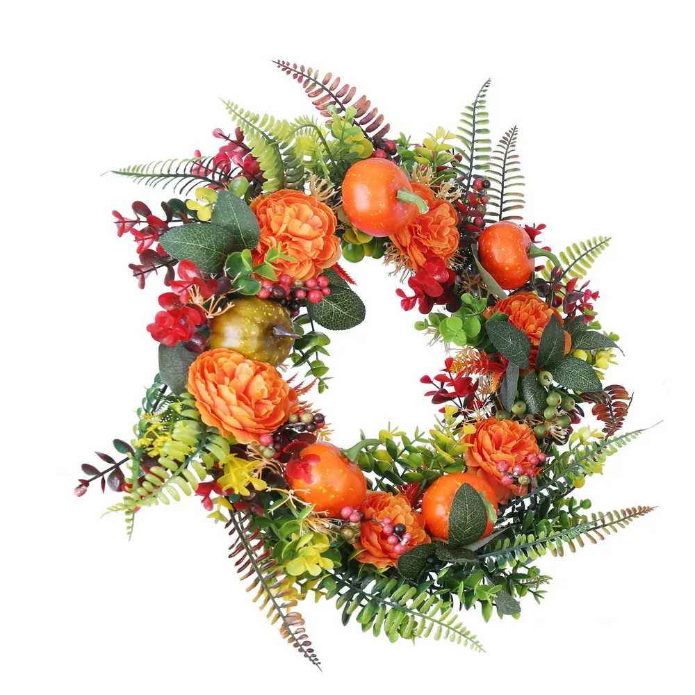 Colorful autumn wreath featuring vibrant orange flowers, green leaves, and decorative fruit embellishments, perfect for seasonal home decor.