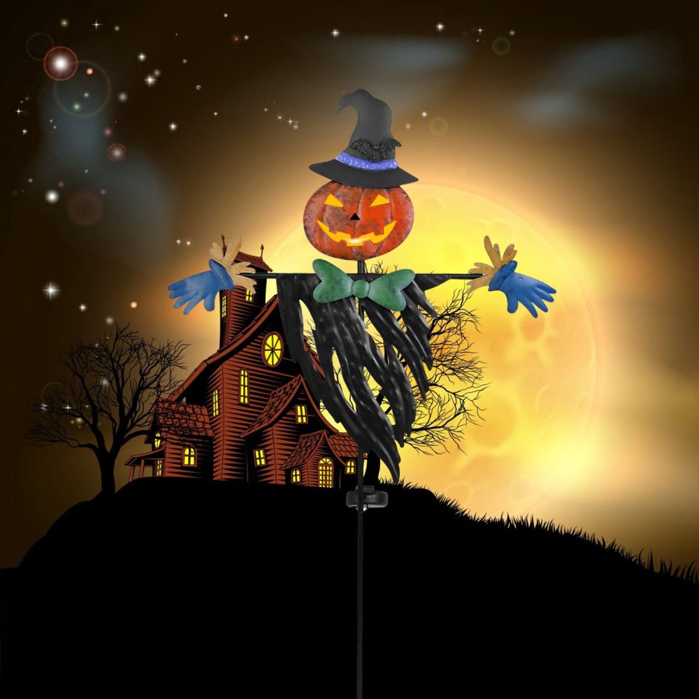 Halloween-themed scarecrow with a carved pumpkin head, witch hat, and colorful gloves, set against a spooky moonlit background featuring a haunted house and bare trees.