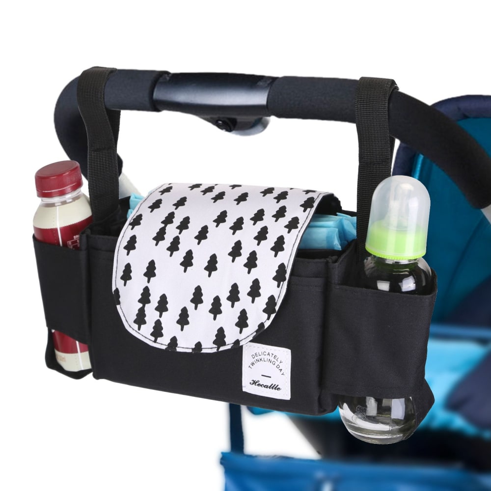 Black stroller organizer with tree-patterned flap, featuring compartments for bottles and baby wipes.