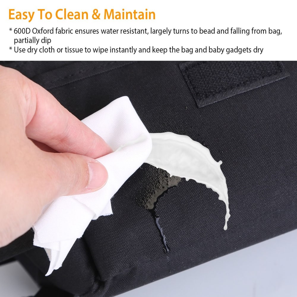 Person using a cloth to wipe a water-resistant black 600D Oxford fabric bag, demonstrating easy cleaning and maintenance for baby gadgets.