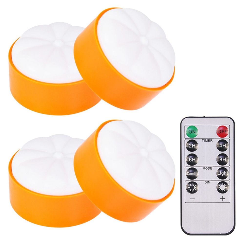 Set of three LED tea light candles with orange bases and white tops alongside a remote control for timer and brightness settings.