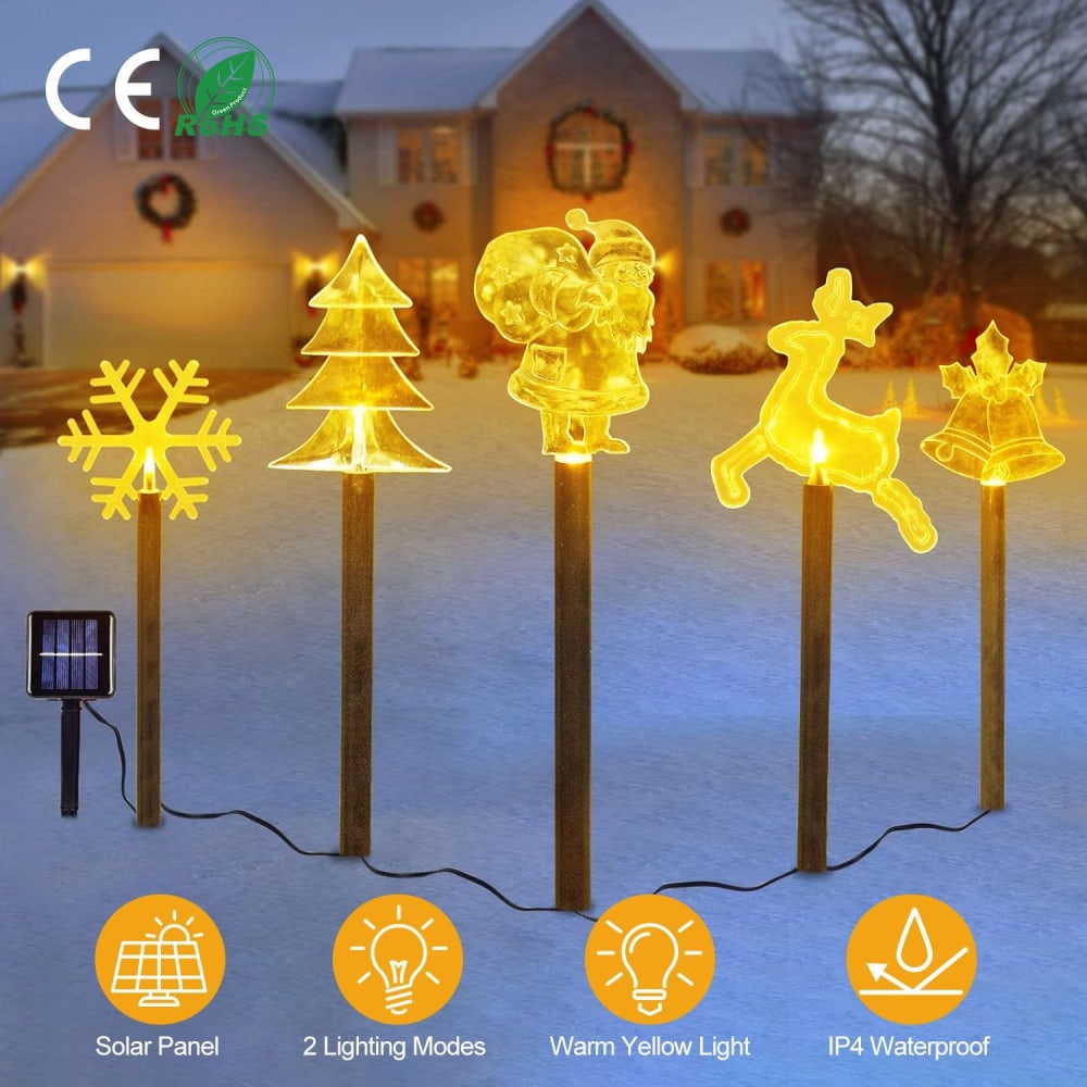 Decorative solar-powered outdoor Christmas lights featuring glowing figures: snowflake, Christmas tree, Santa, reindeer, and bell; warm yellow light, two lighting modes, and IP4 waterproof rating.