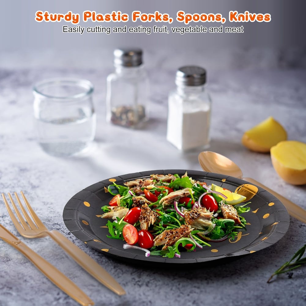 Sturdy plastic forks, spoons, and knives set beside a colorful salad on a decorative plate, showcasing their practical use for cutting and enjoying fruits, vegetables, and meats.