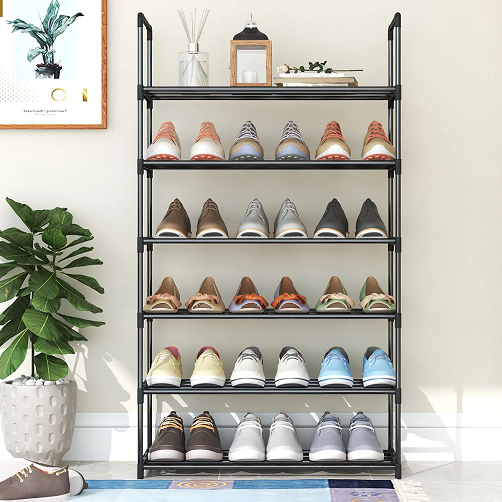 Shoe rack displaying an organized collection of various colorful footwear, including sneakers and sandals, in a stylish home setting with a decorative plant and wall art in the background.