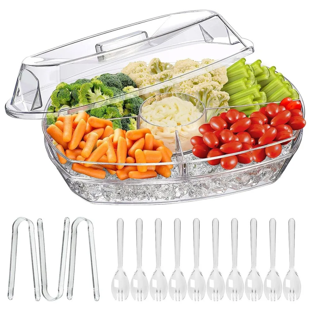 Elegant clear vegetable tray with assorted fresh veggies including broccoli, cauliflower, carrots, celery, and cherry tomatoes, featuring a lid and serving utensils for parties and gatherings.
