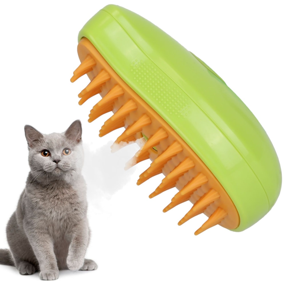 Green pet grooming brush with orange bristles beside a gray cat, designed for effective de-shedding and cleaning of pet fur.