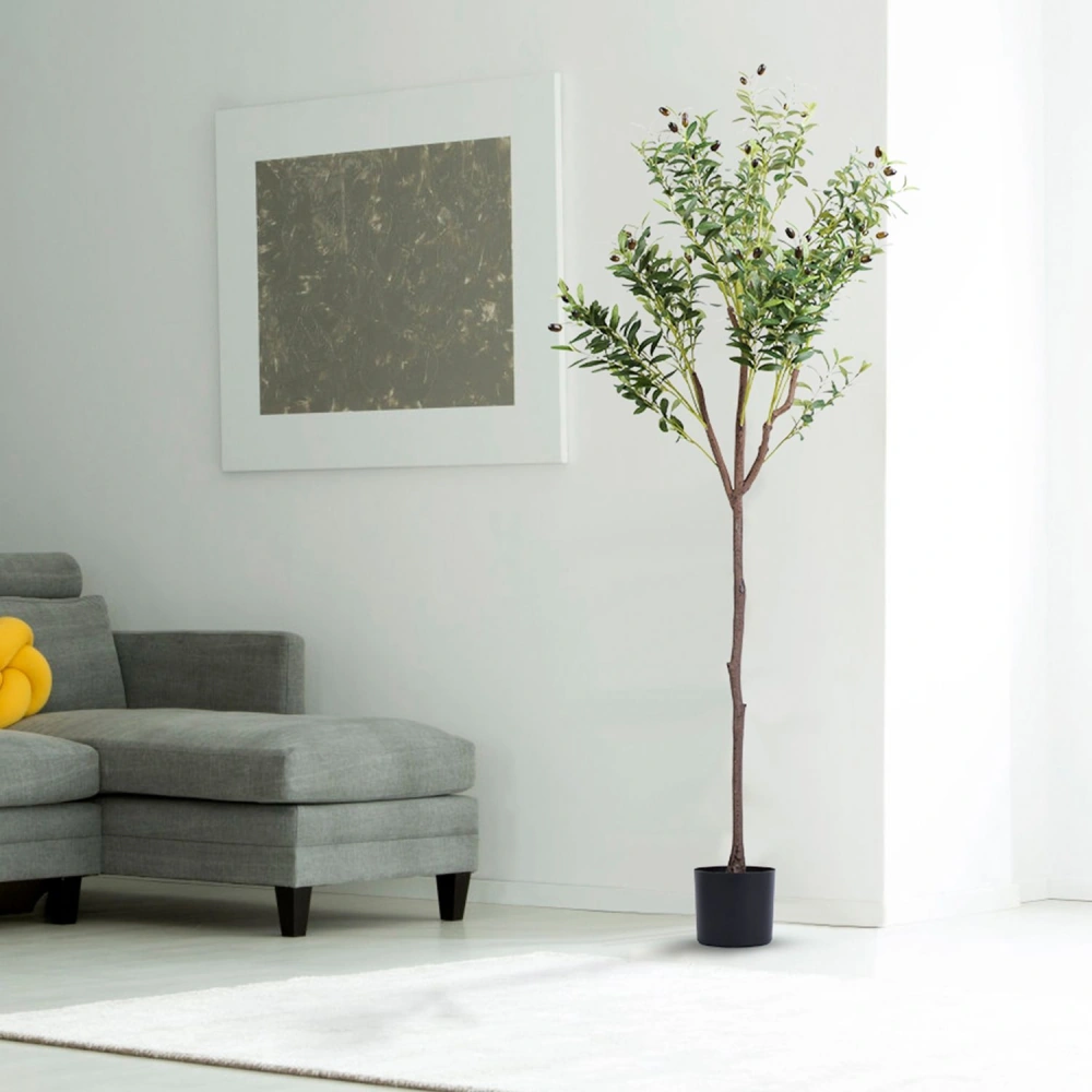 Artificial olive tree in a black pot beside a modern gray couch, enhancing the contemporary living room decor.