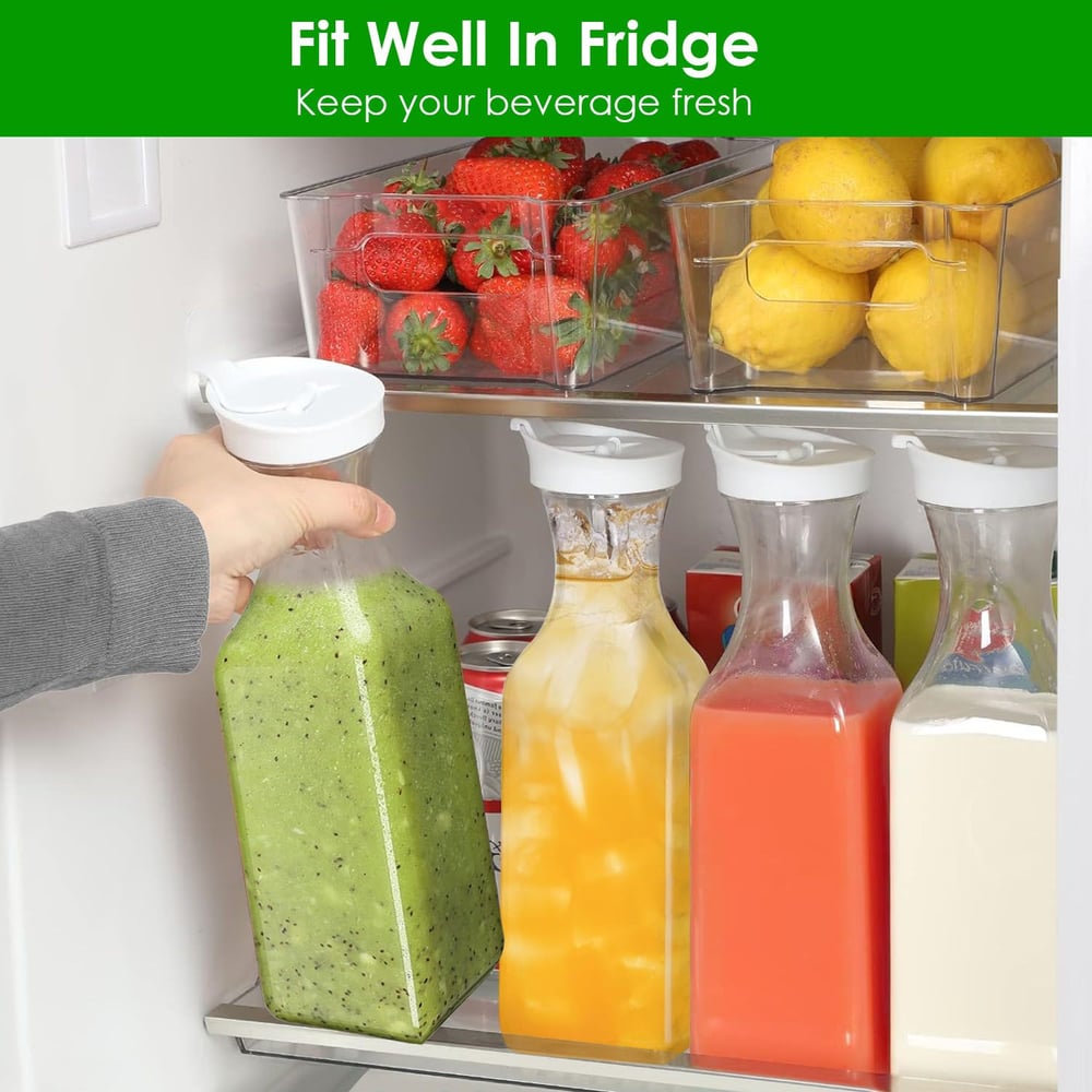 A person holding a green smoothie bottle next to clear containers of fruits and several beverage bottles in a refrigerator, highlighting an organized and fresh drink storage solution.