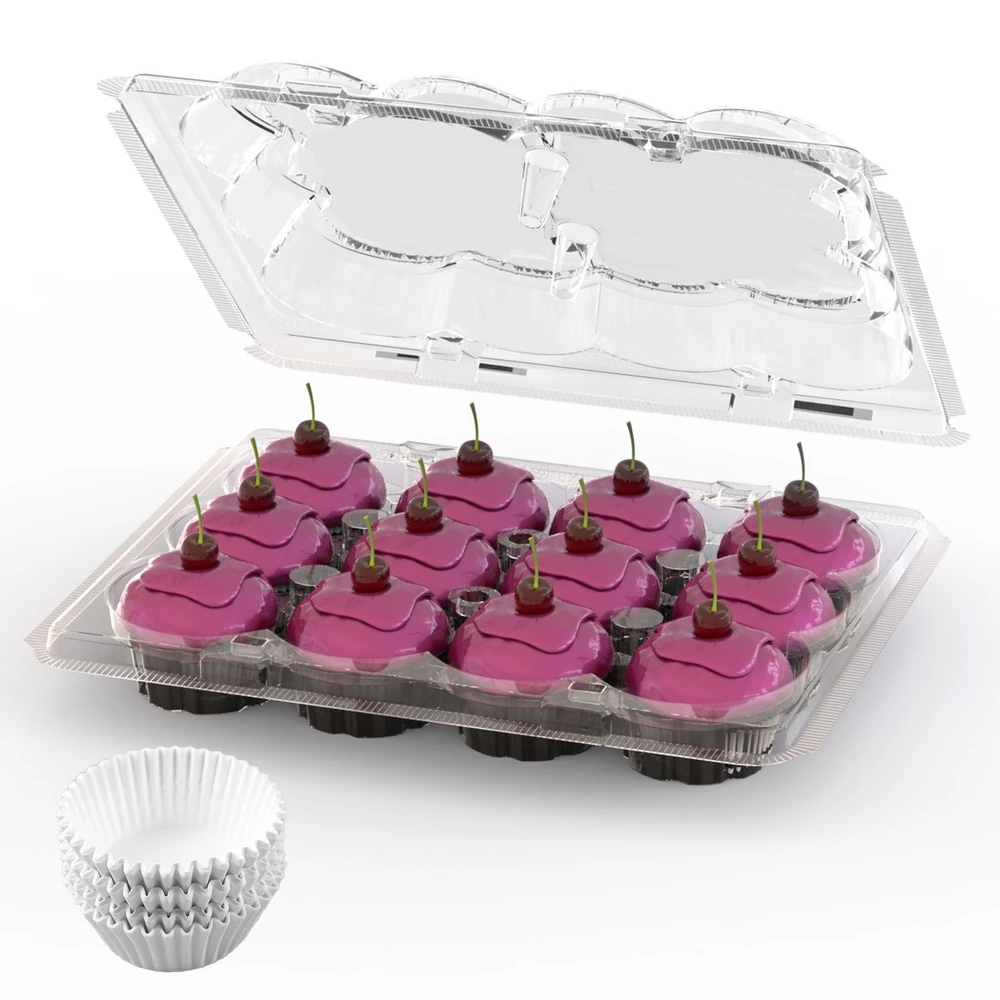 Colorful pink frosted cupcakes with cherries on top displayed in a clear plastic container, accompanied by a stack of white cupcake liners.
