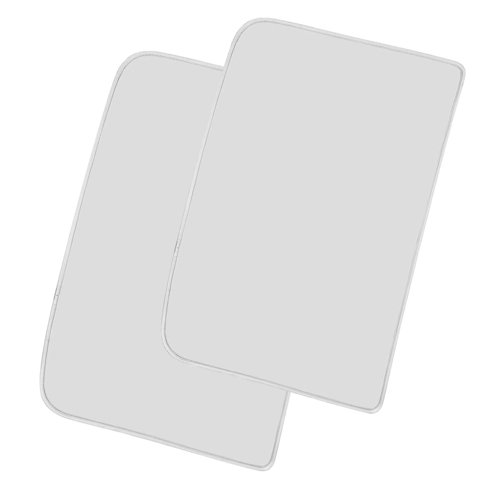 Two soft, gray quilted placemats with rounded corners, ideal for enhancing dining table decor and protecting surfaces.