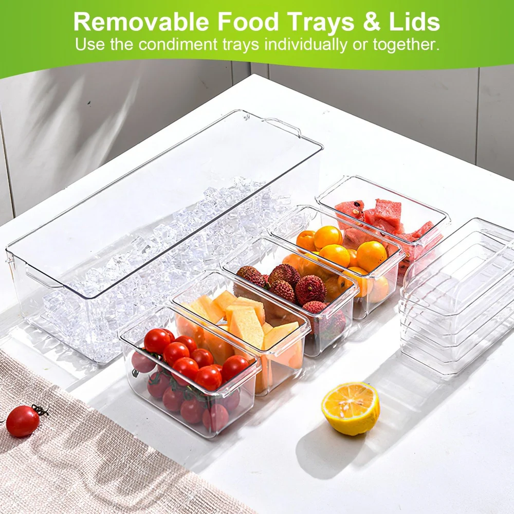Clear removable food trays with lids, containing fresh fruits and vegetables such as tomatoes, melons, and citrus, displayed on a white countertop.