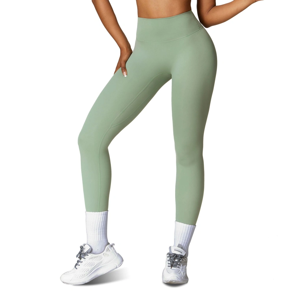 High-waisted mint green leggings modeled by a woman, paired with white athletic socks and sneakers, perfect for workout and casual wear.