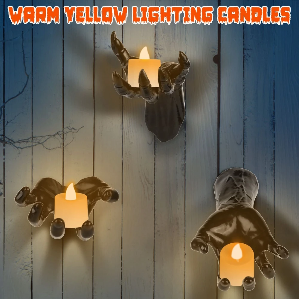 Black hand-shaped candle holders with warm yellow LED candles mounted on a wooden wall, perfect for Halloween décor.