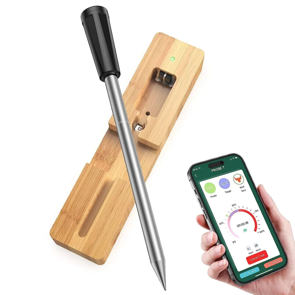 Smart cooking thermometer with stainless steel probe, wooden base, and smartphone app for precise temperature monitoring.