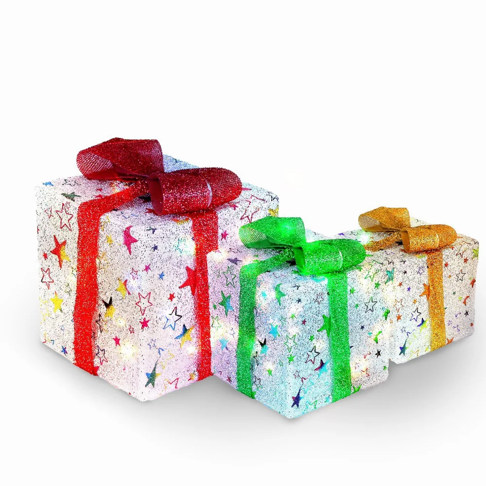 Colorful glittery gift boxes with red, green, and gold ribbons, adorned with star patterns, perfect for festive celebrations.