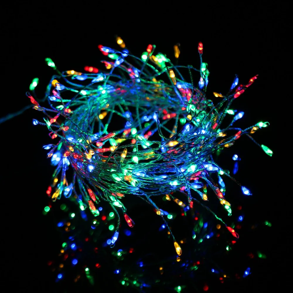 Colorful LED string lights in a tangled bundle, featuring vibrant red, green, blue, and yellow bulbs shining against a dark background, ideal for festive decorations and ambiance.