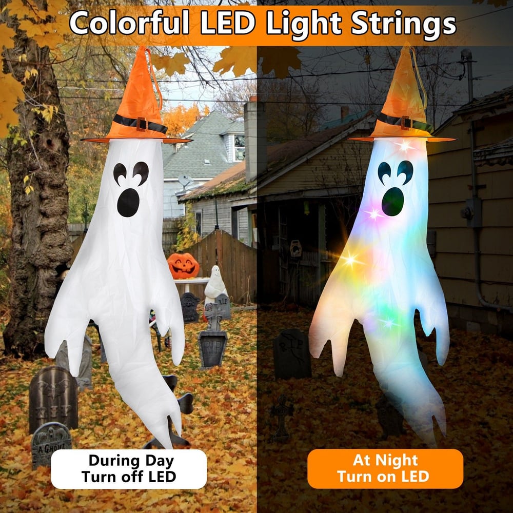 Colorful LED ghost decoration featuring a playful white ghost with a black face and an orange witch hat, shown illuminated at night and unlit during the day, set in a festive Halloween graveyard scene with autumn leaves.