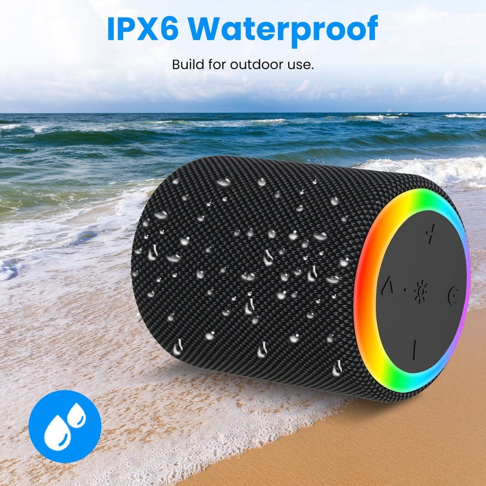 IPX6 waterproof portable Bluetooth speaker designed for outdoor use, featuring a textured black exterior and a colorful control ring, set against a beach backdrop with water droplets.