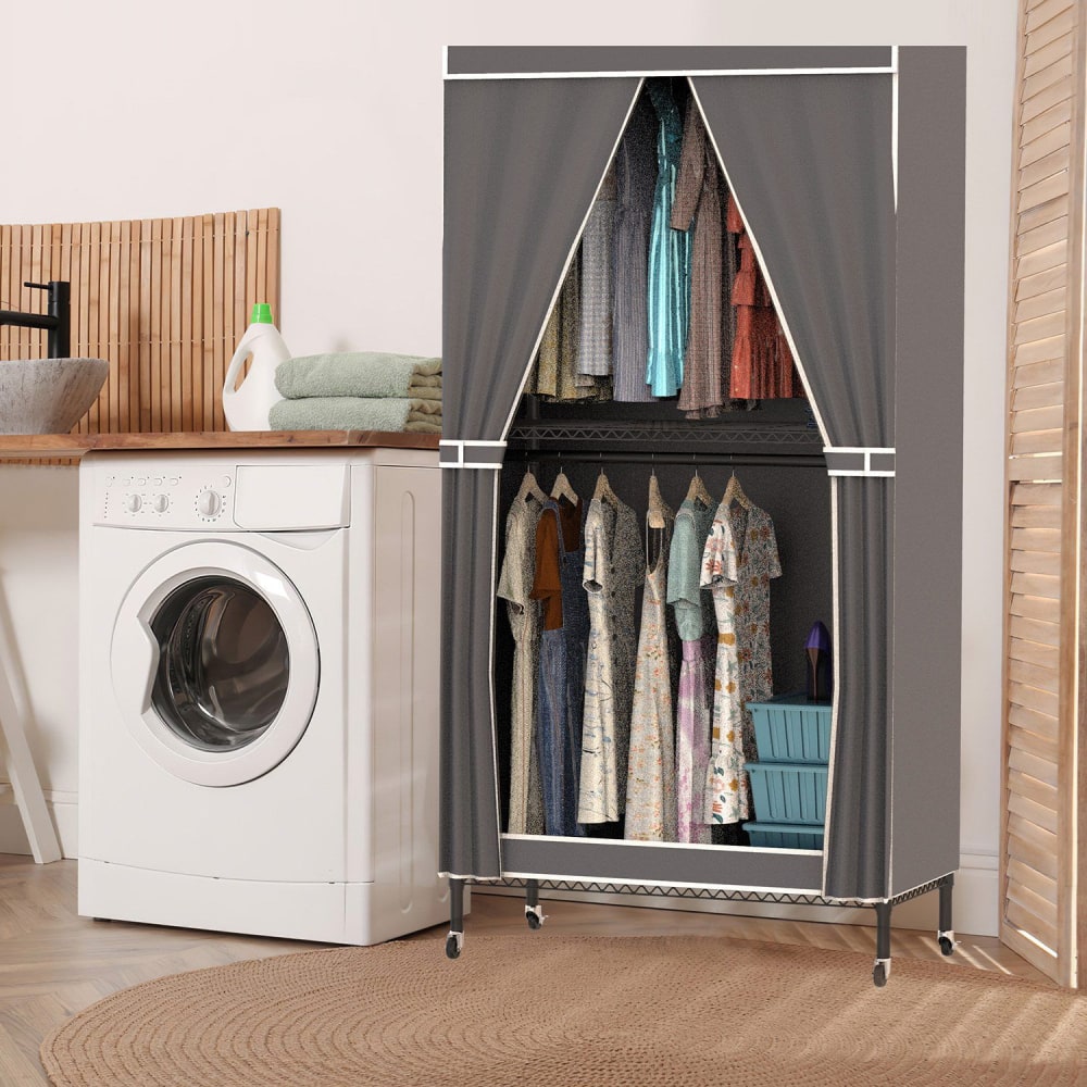 Portable fabric wardrobe with hanging clothes and storage bins, next to a washing machine in a cozy laundry room setting.