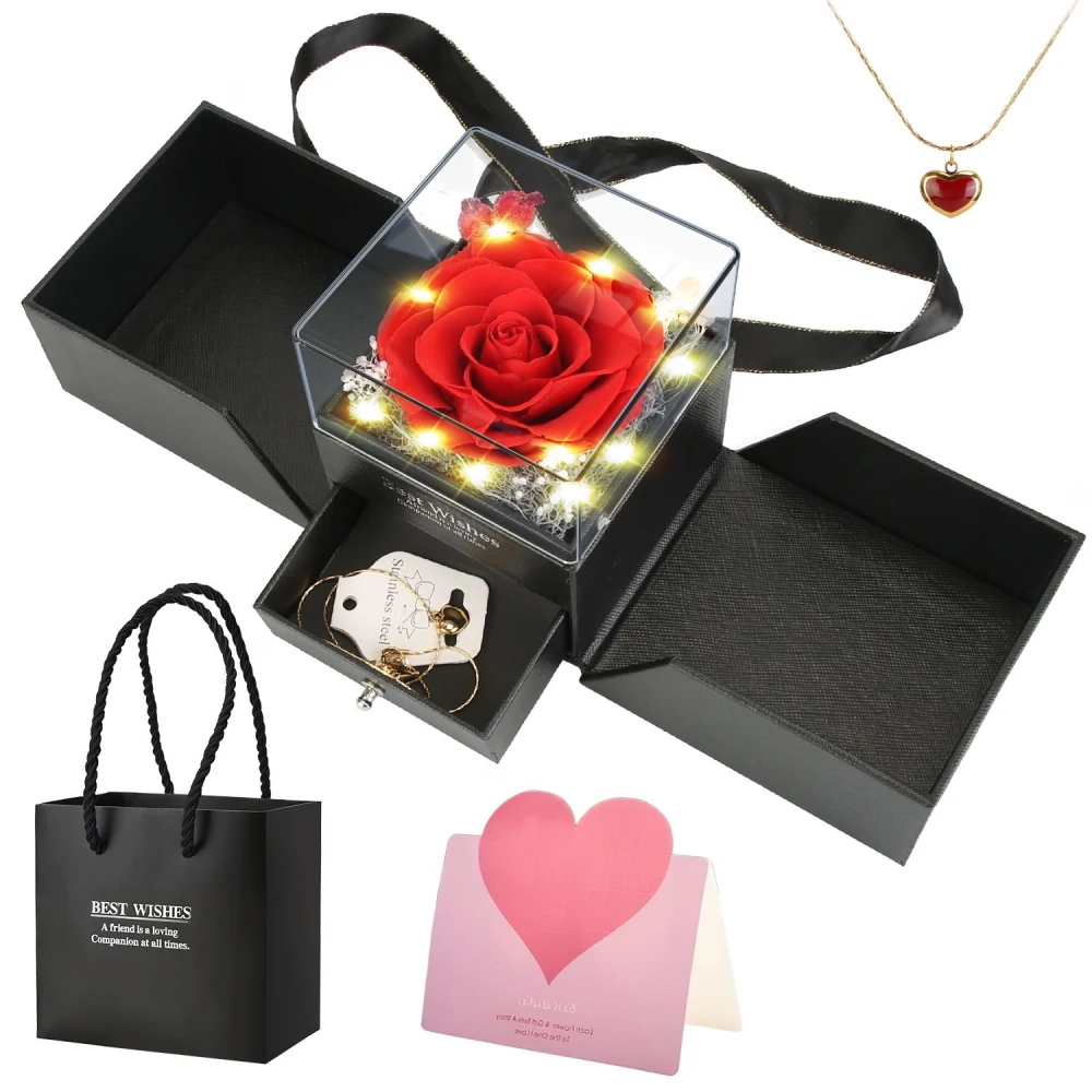 Gift box featuring a beautiful preserved red rose with fairy lights, accompanied by a heart-shaped necklace, earrings, a "Best Wishes" card, and a stylish black gift bag. Perfect for special occasions and thoughtful gifting.
