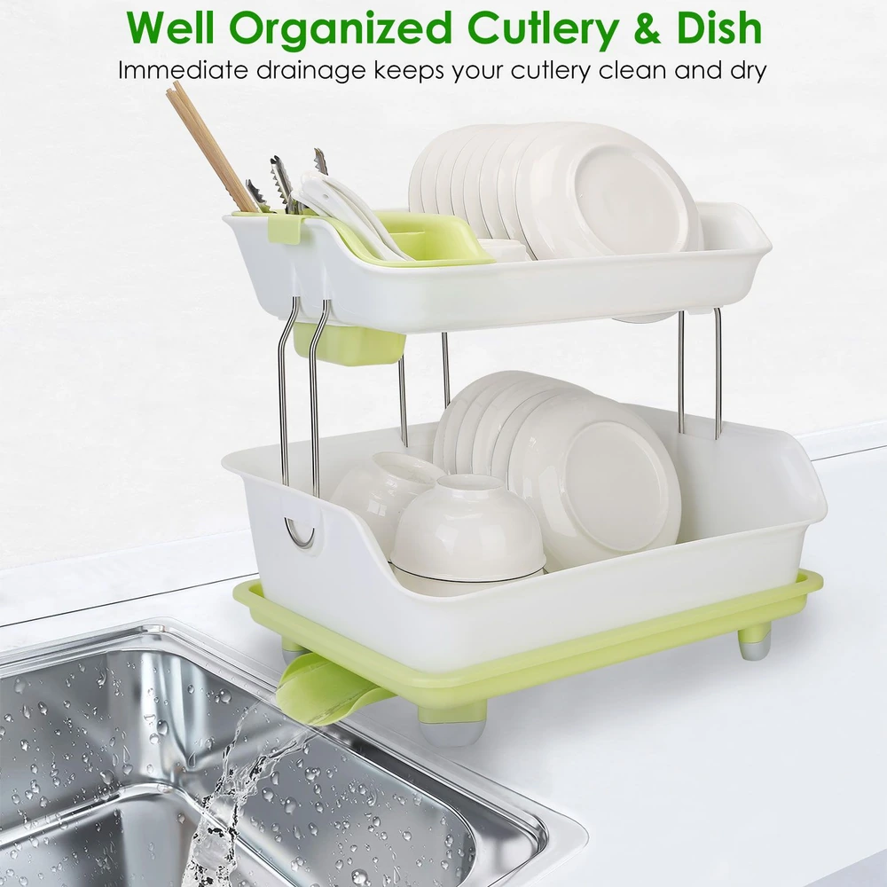 Modern two-tier dish drainer with white trays and green accents, organizing clean plates, bowls, and cutlery while draining water into a stainless steel sink.