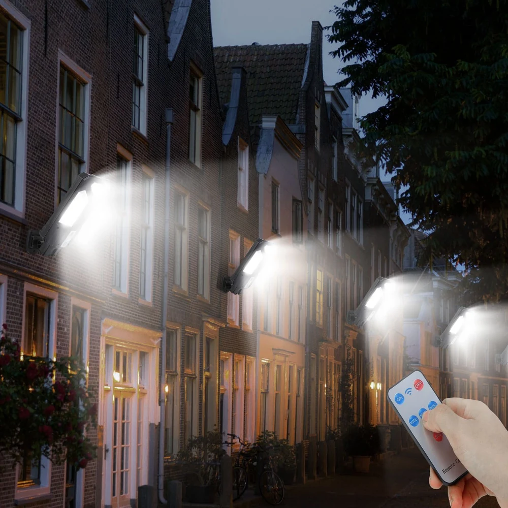 Remote-controlled LED solar lights illuminating a street at dusk, showcasing a hand holding the remote for convenient operation.